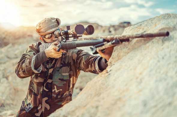 soldier aiming down sight with a sniper rifle